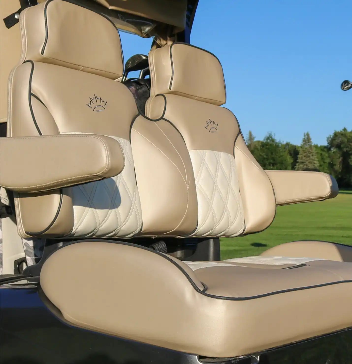 Tan and white golf cart seats.